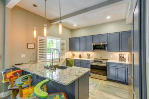 a kitchen with blue cabinets and a counter top at Breezy Key West First-Floor Condo with Pool Access in Key West