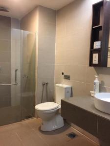 a bathroom with a toilet and a shower and a sink at Nazrins Studio Apartment KBCP in Kota Bharu