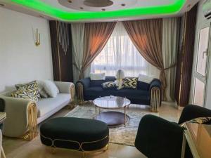 a living room with a couch and a table at شقه فندقية 3غرف بمدينتي امام كرافت زون01117805968 in Madinaty