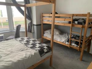 a bedroom with two bunk beds and a bed at St Albans Hotel in Blackpool
