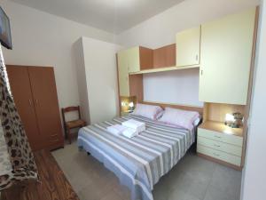 a small bedroom with a bed and a cabinet at B&B Villa Nicoletta in Peschici