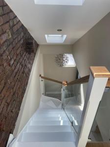 a staircase in a room with a brick wall at Luxury London Oasis in London