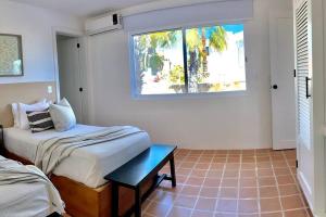 a bedroom with a bed and a window at Private Beach Great Location Condo in El Pueblito
