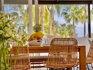 a wooden table with a bowl of fruit on it at Private Beach Great Location Condo in El Pueblito