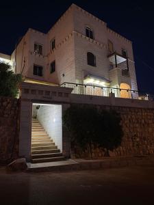 ein Gebäude mit einer Treppe vor einem Gebäude in der Unterkunft Petra Inn House in Wadi Musa