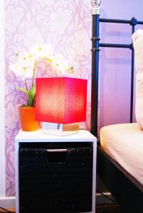 a lamp on a night stand next to a bed at Apartments Rummelsburger Bucht am Ostkreuz in Berlin