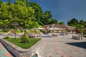 a patio with tables and chairs and umbrellas at WineGarden in Mukacheve