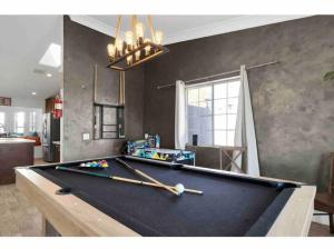 a pool table in a living room with a billiard at Bermuda Fun Oasis in Bermuda Dunes