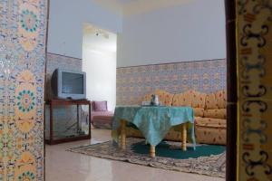 a living room with a table and a couch at Spacious Apartment Calm Area Near the Medina in Chefchaouen
