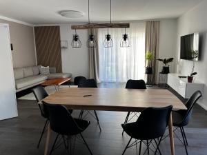 een woonkamer met een houten tafel en stoelen bij Hochwertiges Haus mit Garten mit guter Anbindung in Berlijn