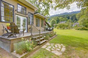 une maison dotée d'une terrasse couverte avec 2 chaises. dans l'établissement Cozy Artists Cottage 3 Mi to Lookout Mtn!, à Chattanooga