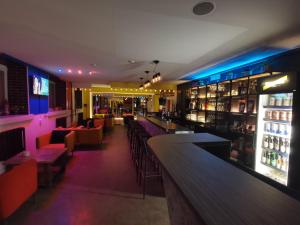 a bar with tables and chairs in a restaurant at Tiki Taka Hostel & Pub in Vilnius
