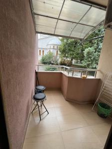 a balcony with a chair and a view of a building at Room Iva in Sandanski +6 photos