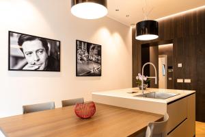 a kitchen and dining room with a table and a sink at La Dolce Vita Luxury Apartment in Rome