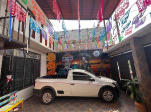 a room with a white car parked in it at CASA CEMPOAL in Oaxaca City