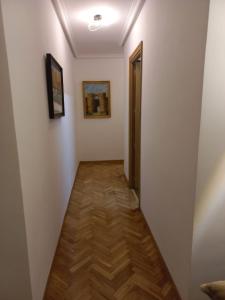 a hallway with white walls and a wooden floor at CASA ESQUILAS in Avila