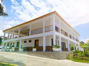 a white building with two balconies on it at Colina del Sol Hotel Hacienda in Quimbaya