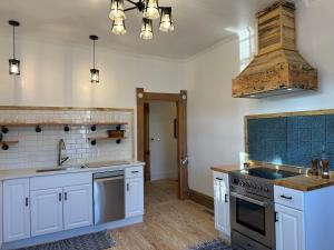 a kitchen with white cabinets and a stove top oven at The Cottage at 241 North in St. George