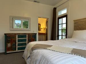 a bedroom with a large bed and a window at The Cottage at 241 North in St. George