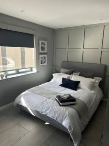 a bedroom with a large white bed with a window at Modern Annex in Kent