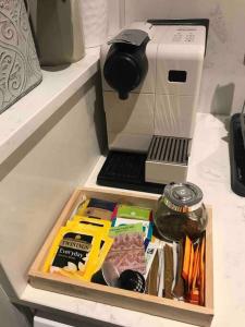 a coffee maker sitting on a counter with food at Modern Annex in Kent