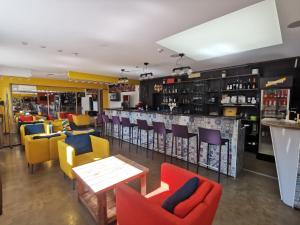 a restaurant with colorful chairs and a bar at Bar-celona in Vilnius