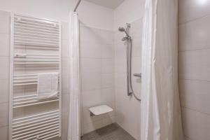 een witte badkamer met een douche en een toilet bij Traumhaftes Domizil mit Tiefgarage in Stade