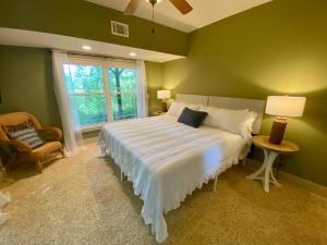 a green bedroom with a large bed with a window at New Listing! Mountainview Escape in Dahlonega
