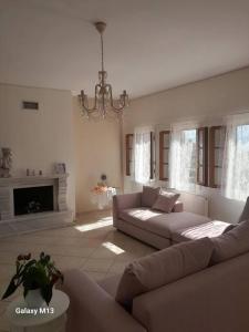 a living room with a couch and a fireplace at Ioannina Cozy Hill House in Pedini