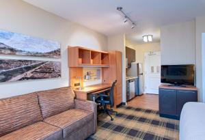 a living room with a couch and a desk with a computer at TownePlace Suites by Marriott Billings in Billings