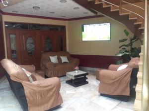 uma sala de estar com duas cadeiras e uma mesa em Hotel Casa Grande F&J em Potosí