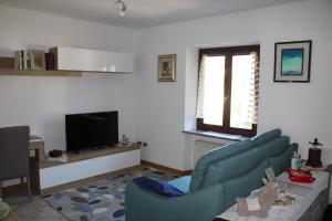 a living room with a couch and a tv at VILLA ADRY Mon Reve Holidays in Aosta