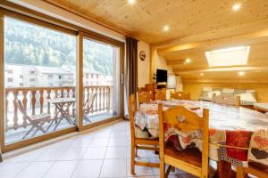 a room with a bed and a large window at La turra in Lanslebourg-Mont-Cenis