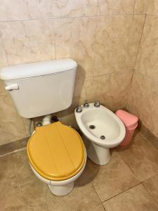 a bathroom with a toilet and a sink at Wara in Cafayate