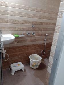 a bathroom with a sink and a toilet and a shower at Hari Kripa Sadan in Ayodhya