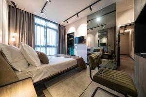 a hotel room with a bed and a living room at VELVET rooms & more in Zadar