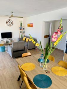 a living room with a table and chairs and a couch at Sunny Side Up in Grand Baie