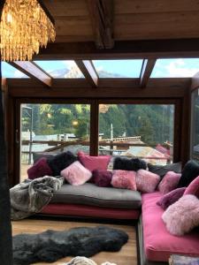a living room with a couch with pillows on it at chalet Sestriere in Champlas du Col