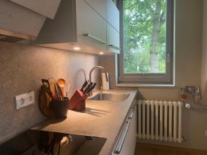 a kitchen counter with a sink and a window at copper beech place in Achim