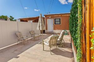 a patio with chairs and a table and an umbrella at Stylish Uptown Butte Condo - 632 in Butte