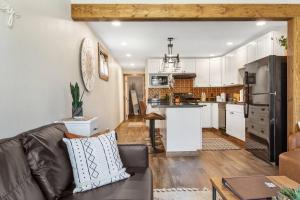 a living room with a couch and a kitchen at Stylish Uptown Butte Condo - 632 in Butte