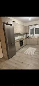 a kitchen with a stainless steel refrigerator and a window at Villa NIMEDA in Nikiti
