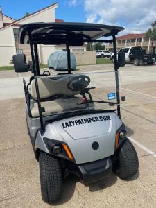 a golf cart parked in a parking lot at Lazy Palm Panama City Beach Free New 2023 Golf Cart! Across street From Beach! in Panama City Beach