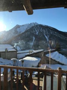 a view of a snow covered mountain from a deck at chalet Sestriere in Champlas du Col