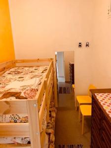a bedroom with two bunk beds and a table and chairs at La Casina di Isola in Livorno