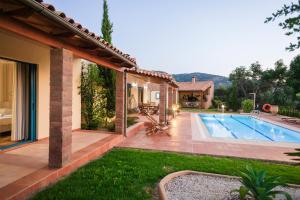 a house with a swimming pool in a yard at Villa Givera in Giannoudi