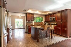 a large kitchen with wooden cabinets and a counter top at Charming Duplex Home in Sherman Oaks in Los Angeles