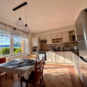a kitchen and dining room with a table and chairs at Apartmán Cimca in Cheb