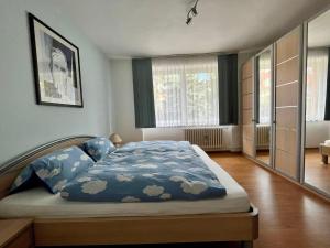 a bedroom with a bed with a blue comforter at Apartmán Cimca in Cheb