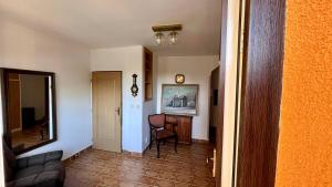 a living room with a couch and a mirror at Apartmán Cimca in Cheb